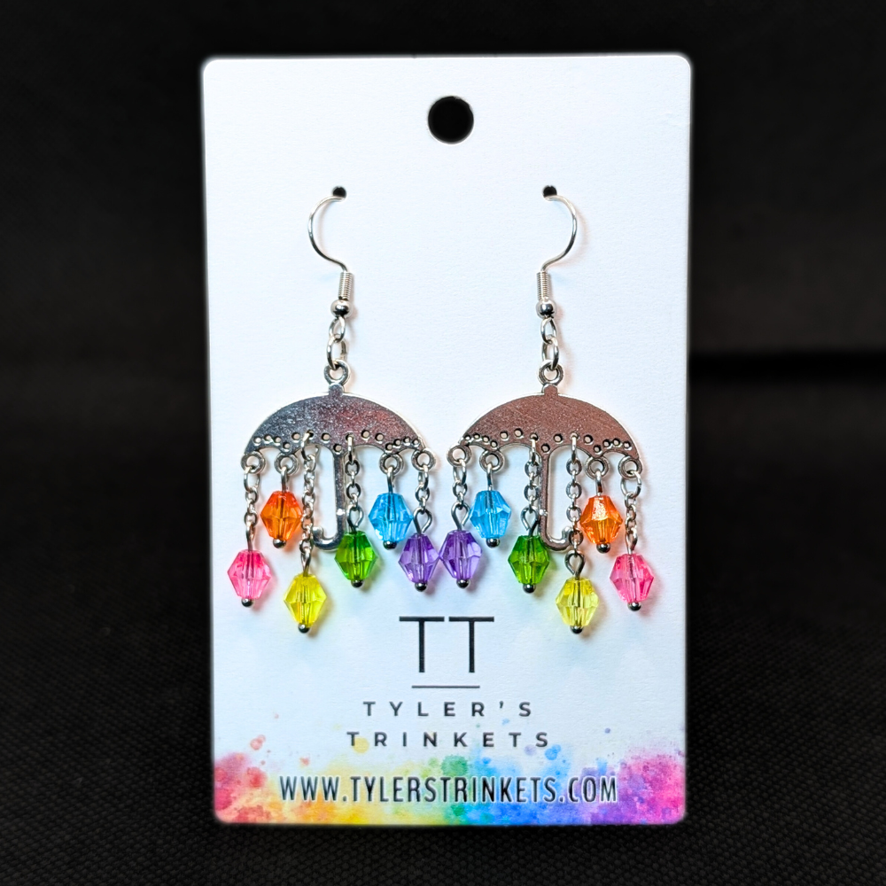 Dangle earrings made from an umbrella-shaped charm and multi-colored beads on an ear-wire style hook.
