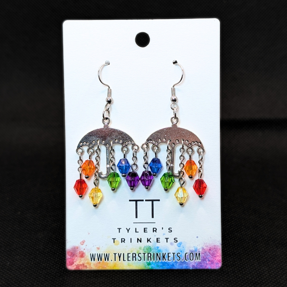 Dangle earrings made from an umbrella-shaped charm and multi-colored beads on an ear-wire style hook.