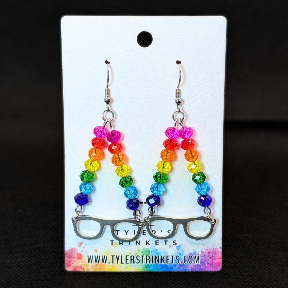 Dangle earrings made from an eye glasses shaped charm and multi-colored beads on an ear-wire style hook.