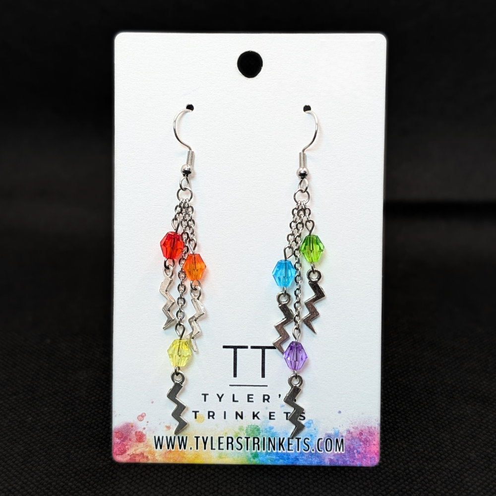 Dangle earrings made from several lightning bolt-shaped charms and multi-colored beads on varying lengths of chain, suspended on an ear-wire style hook.